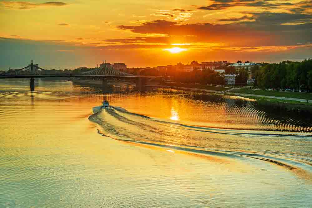 Best Ways to Explore Russia. Motor ship at sunset sails on river Volga in Tver, Russia